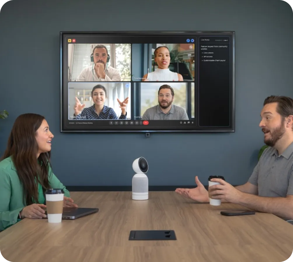Vibe Bot on conference table connecting in-room team to remote video call participants with AI-powered live notes on screen