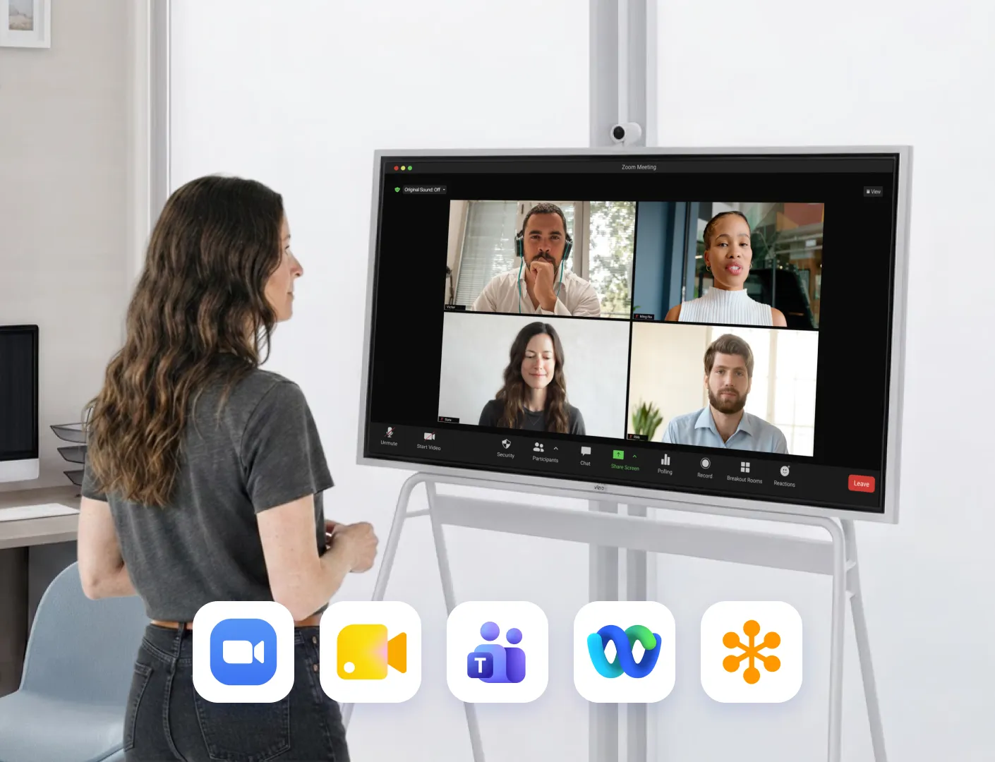 Woman on a Zoom call on Vibe Board at home, with Google Meet, Teams, Webex and GoTo app icons below