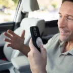 Man using Vibe Dot on phone for automated task execution via voice commands
