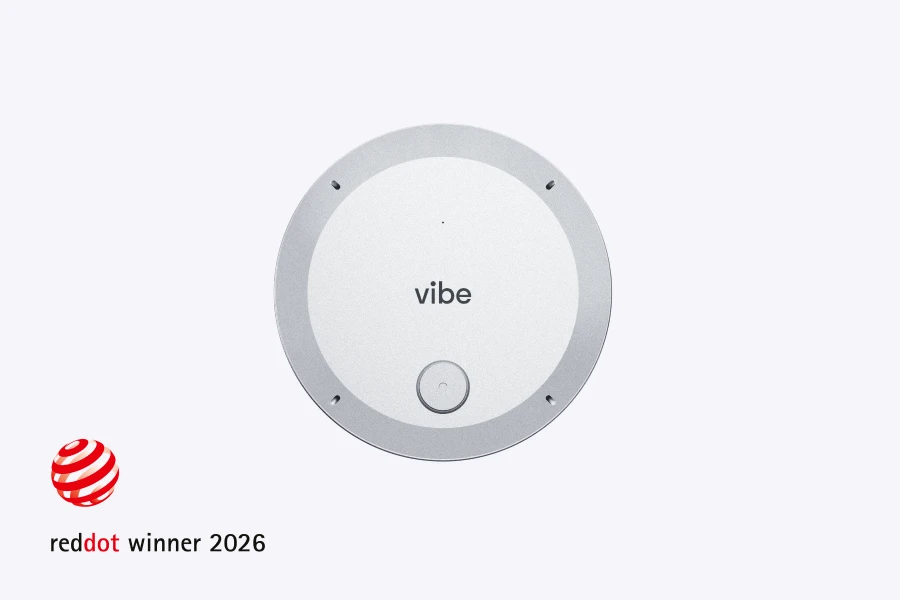 Vibe Dot portable AI recorder top view with center button and mic openings, Red Dot Winner 2026 badge