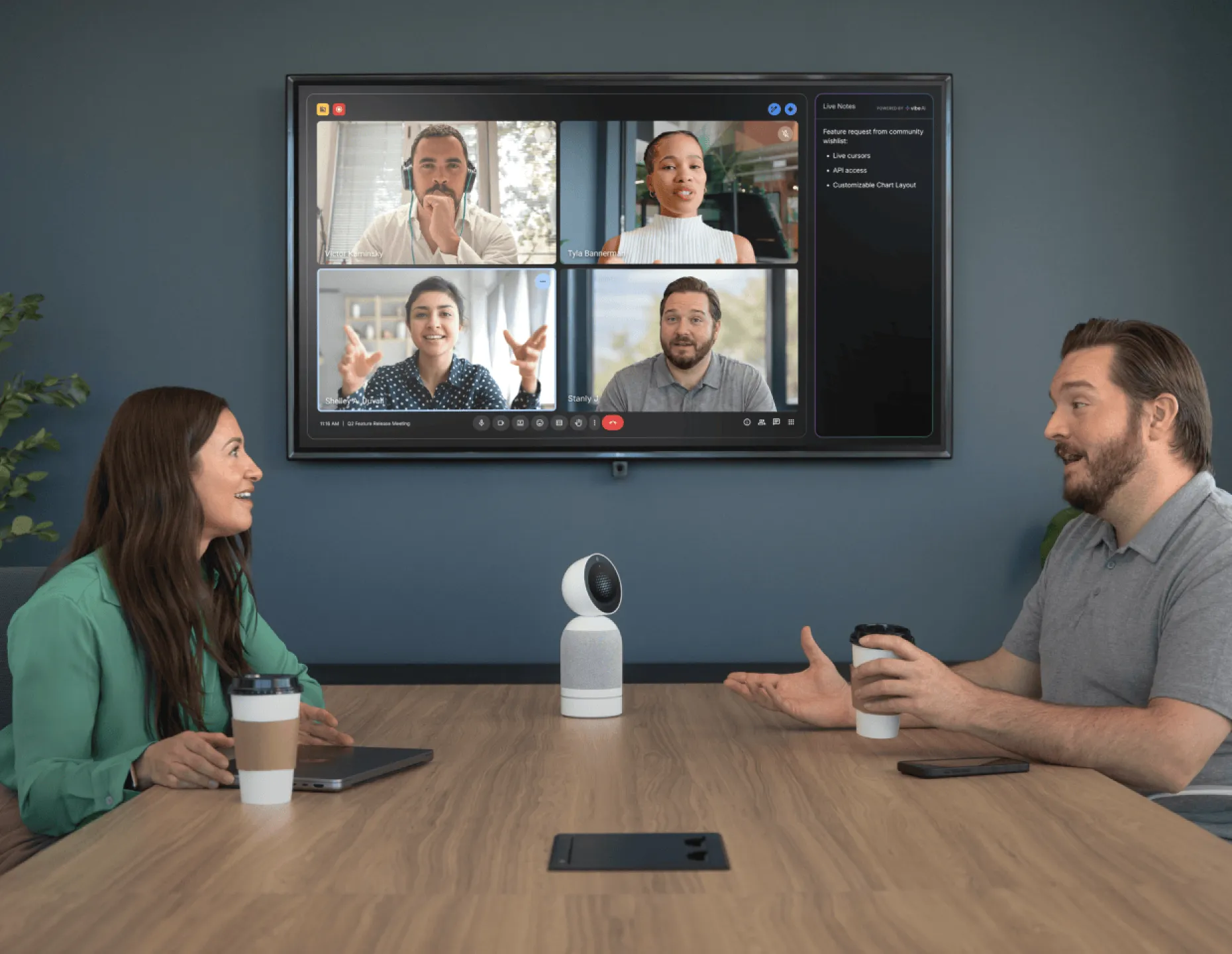 Vibe Bot on conference table connecting in-room team to remote video call participants with AI-powered live notes on screen