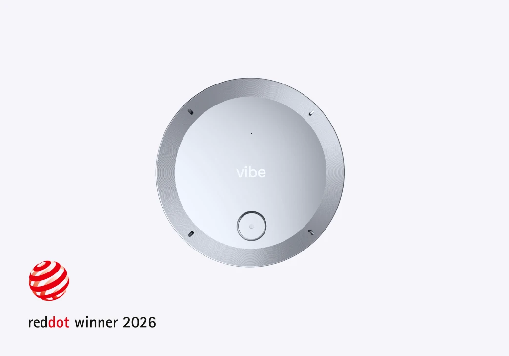 Vibe Dot portable AI recorder top view with center button and mic openings, Red Dot Winner 2026 badge