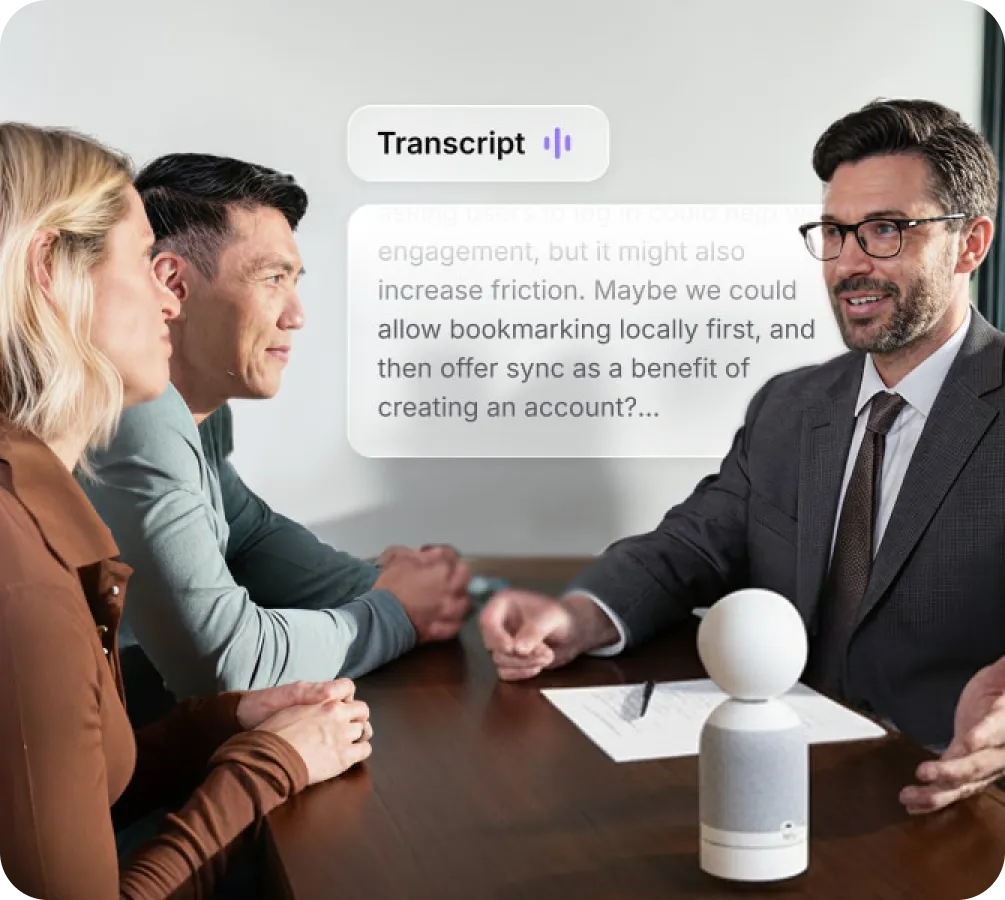 Vibe Dot on conference table capturing live transcript of business meeting discussion between three people