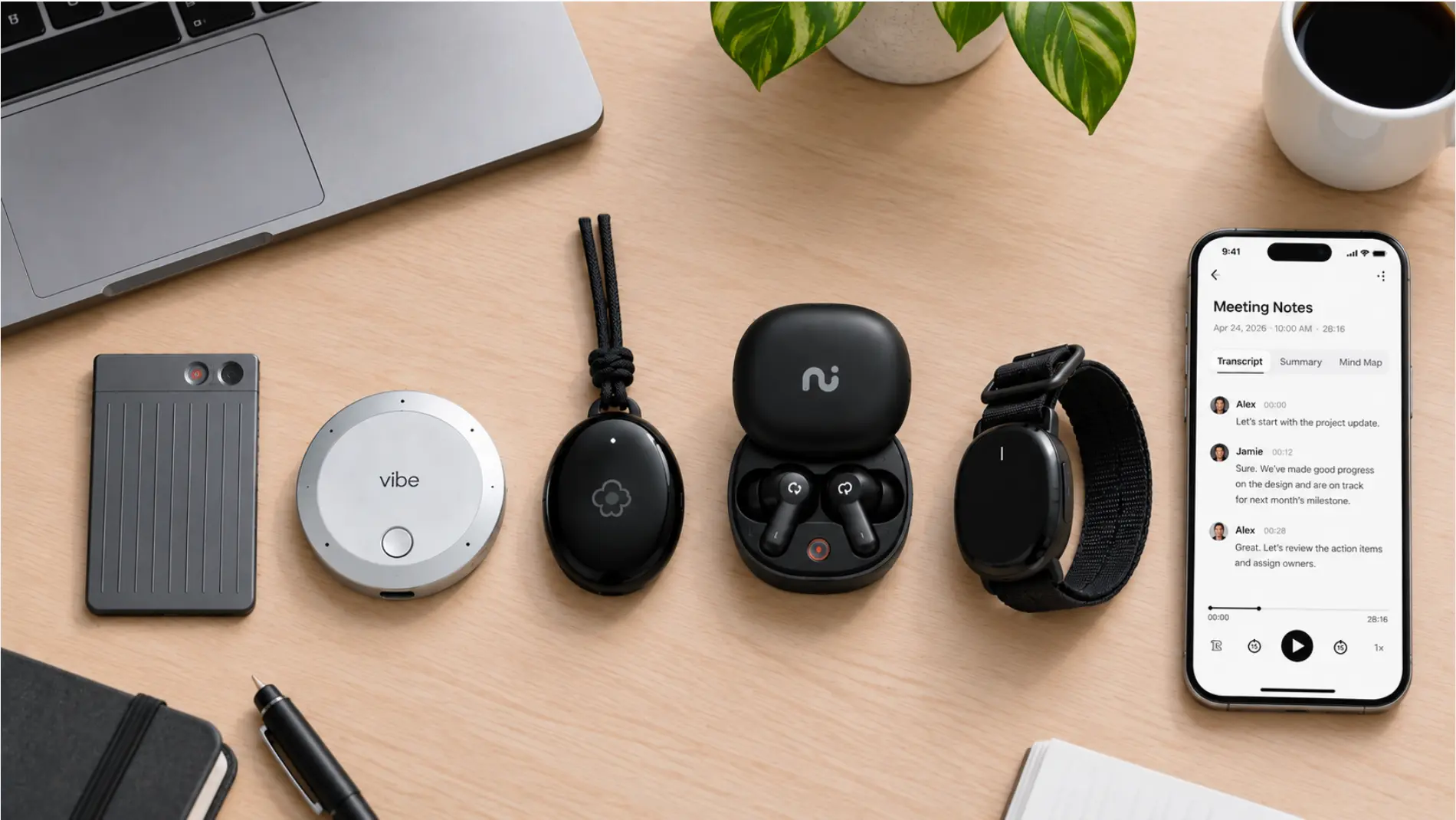 Overhead flat lay of the compared devices and a phone showing a note-taking app, on a plain desk