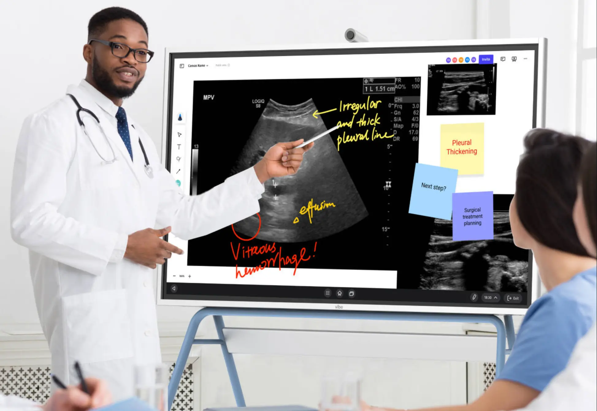 A clinical training room with Vibe Board S1 Pro showing a medical imaging scan, an attending physician annotating directly on the display with a stylus