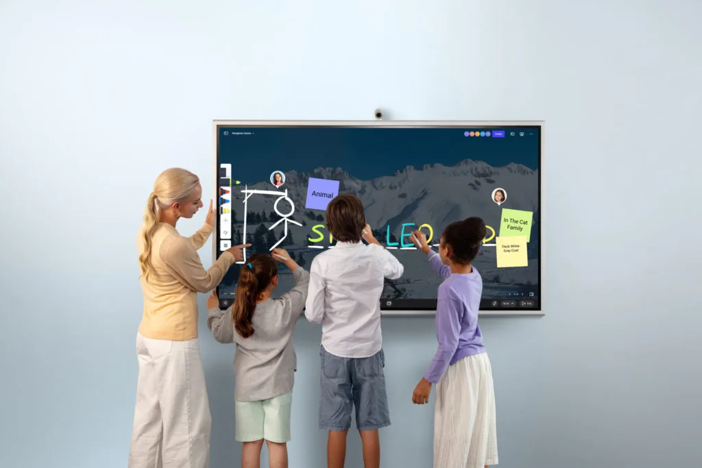 A group of students and the teacher standing in front of Vibe Board S1