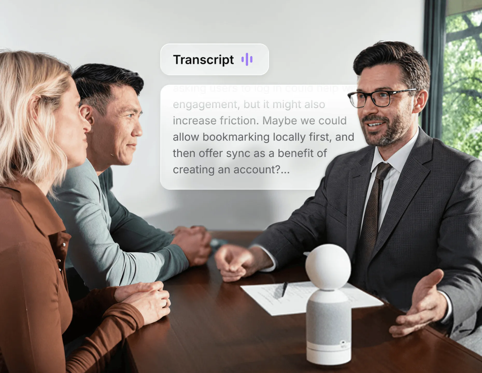 Vibe Dot on conference table capturing live transcript of business meeting discussion between three people