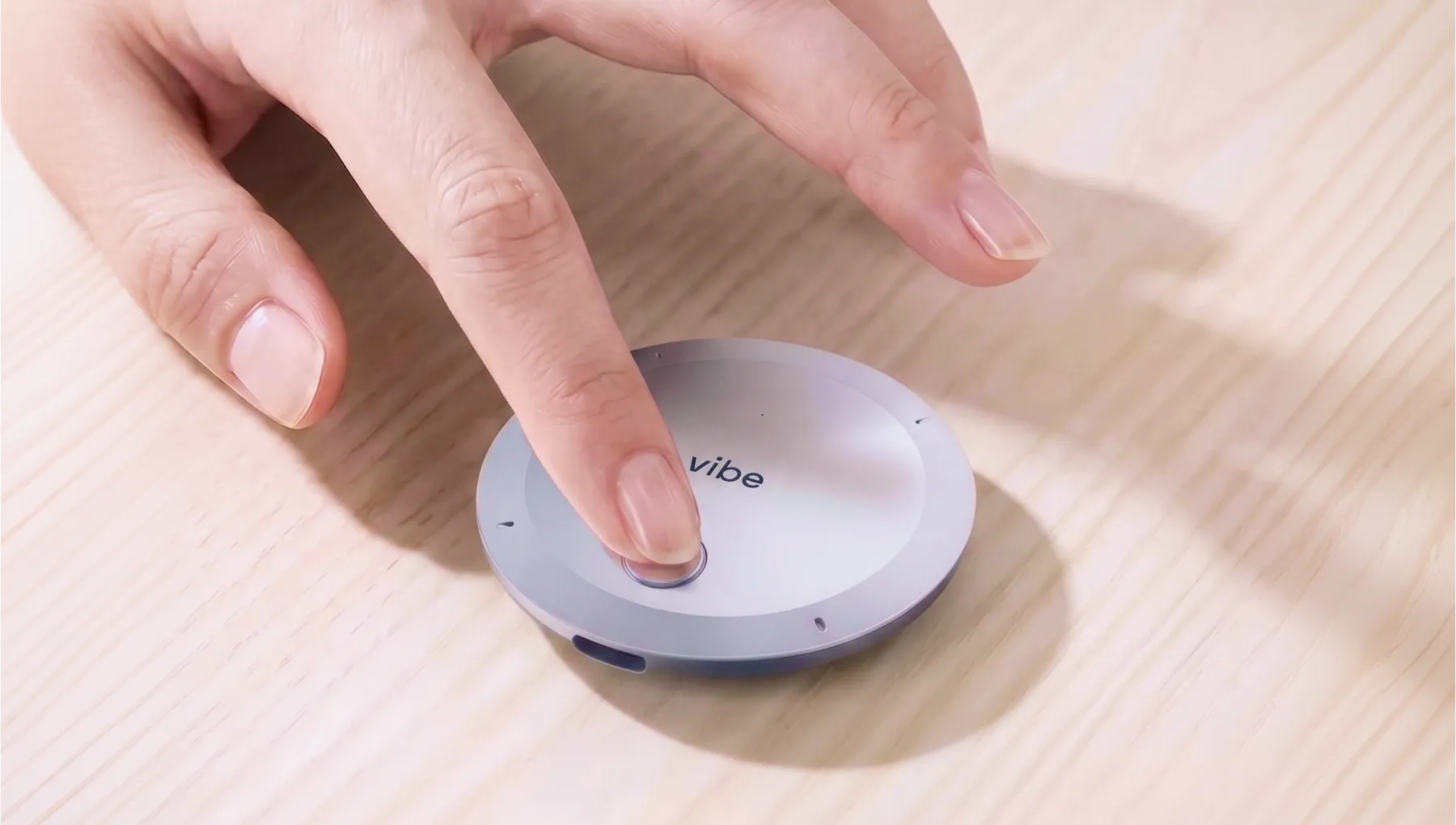 Finger tapping Vibe Dot AI note taker to activate it