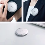 Vibe Dot AI note taking device attached to phone, clipped on jacket lapel, and placed on desk